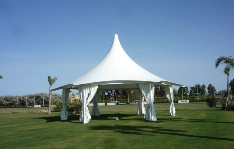 Carpa para eventos tipo pagoda abierta con cortinas laterales en un espacio exterior.